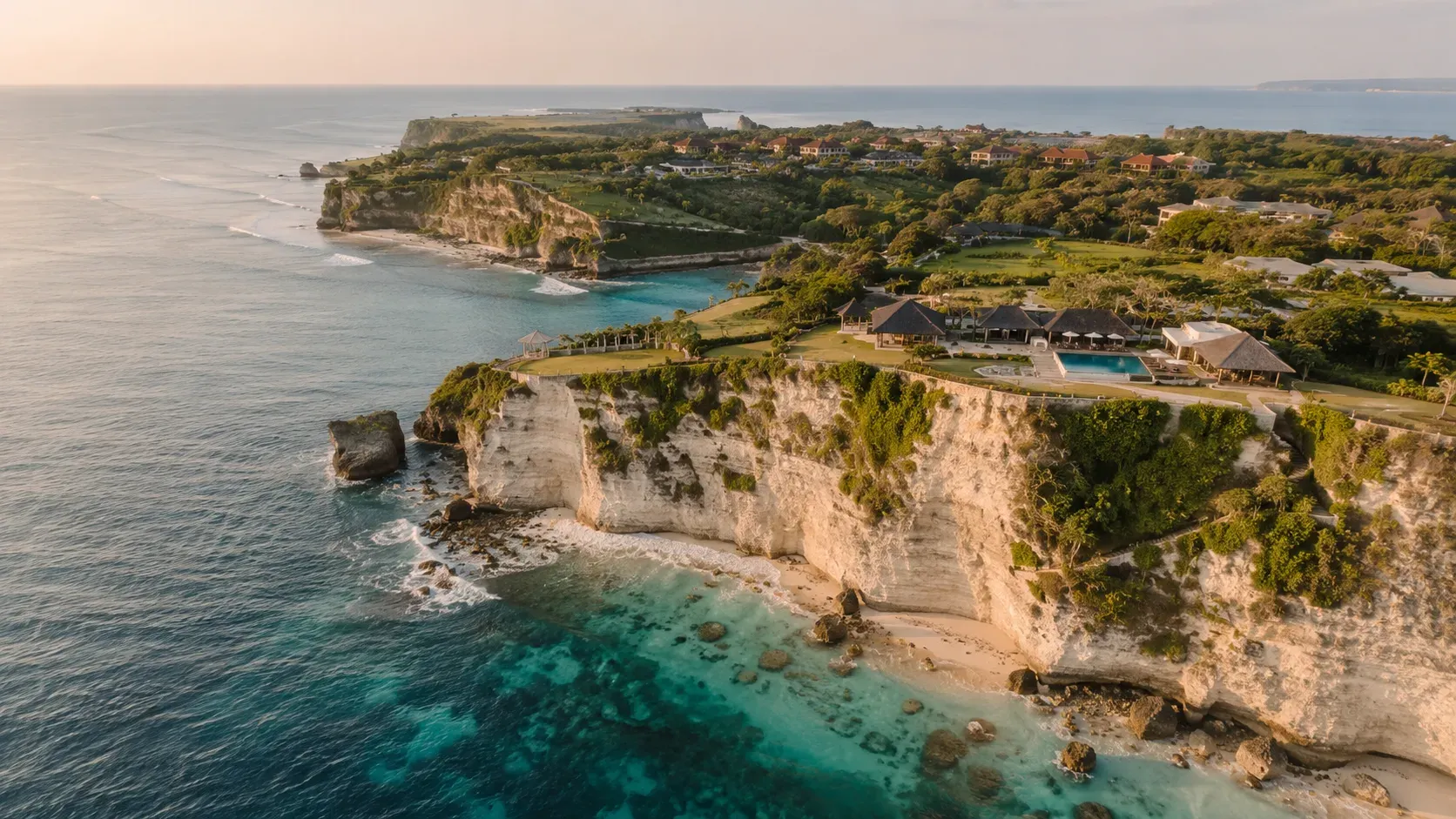 Aerial view of the Bukit peninsula coastline in Bali: limestone cliffs, reef-protected water and the Nusa Dua resort greenery