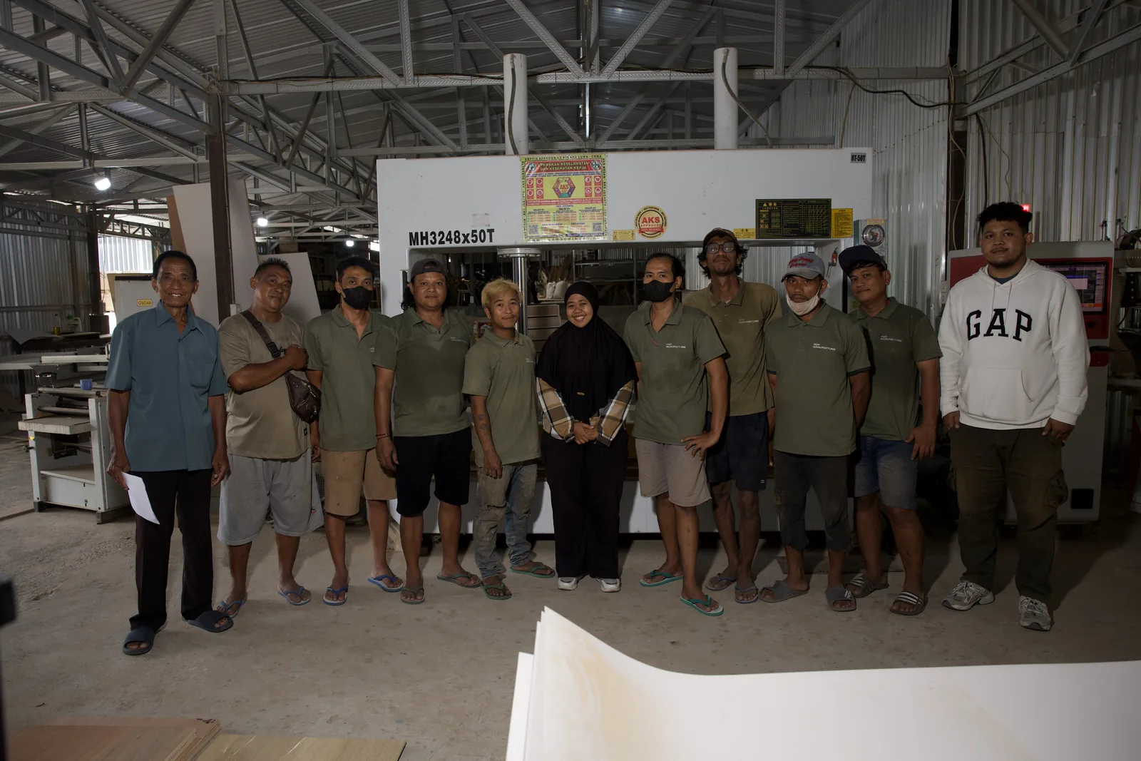 The HQC furniture factory team on the workshop floor