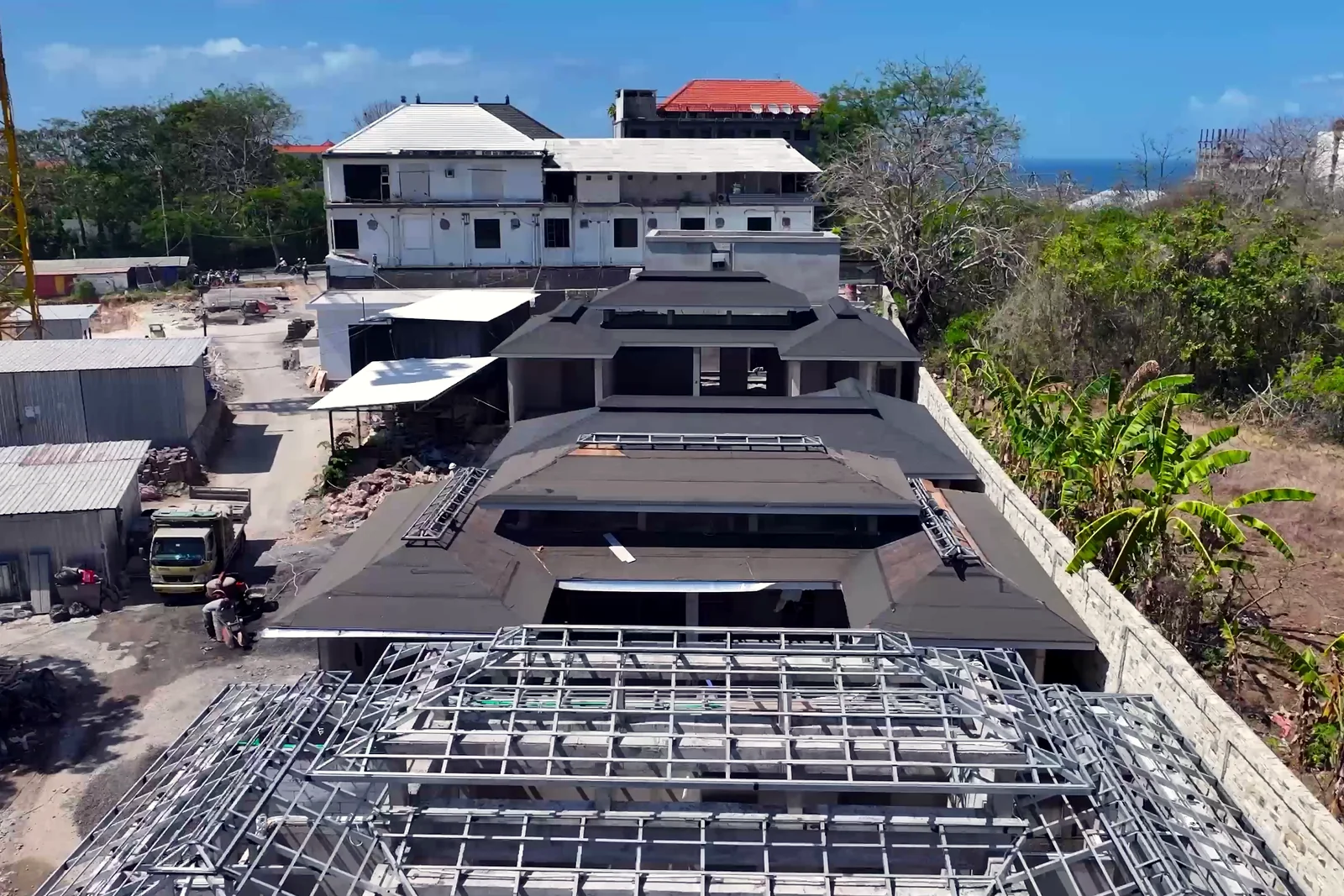 Satori villa roofs and the tower crane, from the August 2026 site report