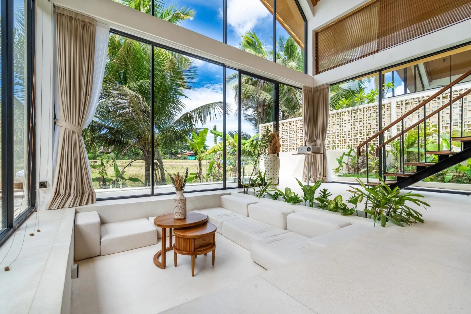 Dzen double-height boho living room with rice-field view