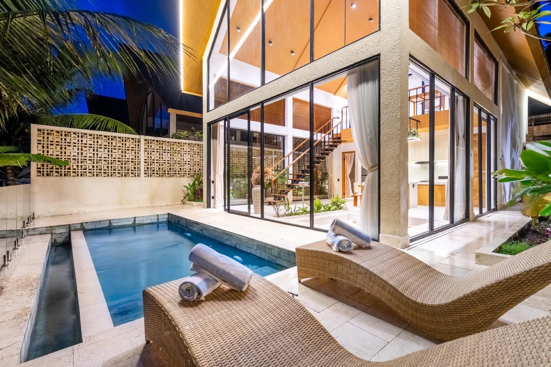 Dzen Green Fields villa at twilight with infinity pool